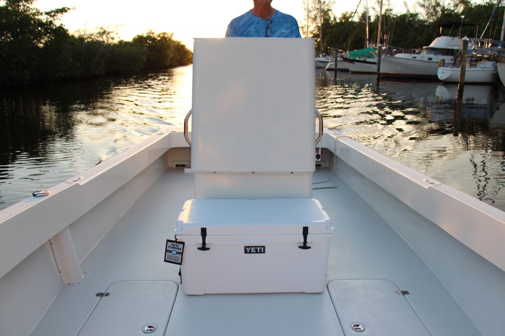 Deck and console of an Atlas Boatworks 23F with a Yeti brand cooler