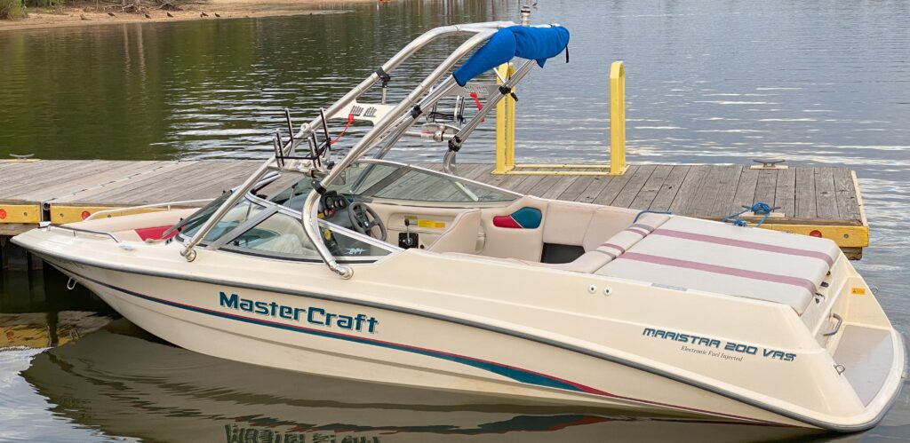 Side view of Mastercraft Maristar 200VRS ski boat with Big Air tower tied to a dock.