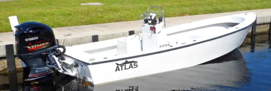 Side view of Atlas Boatworks 23F center console fishing boat tied to a seawall. 200hp yamaha vmax engine on the back.