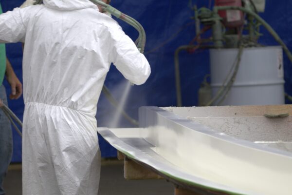 White gelcoat is sprayed onto the mold of a deck cap for the Atlas Boatworks Demo Boat