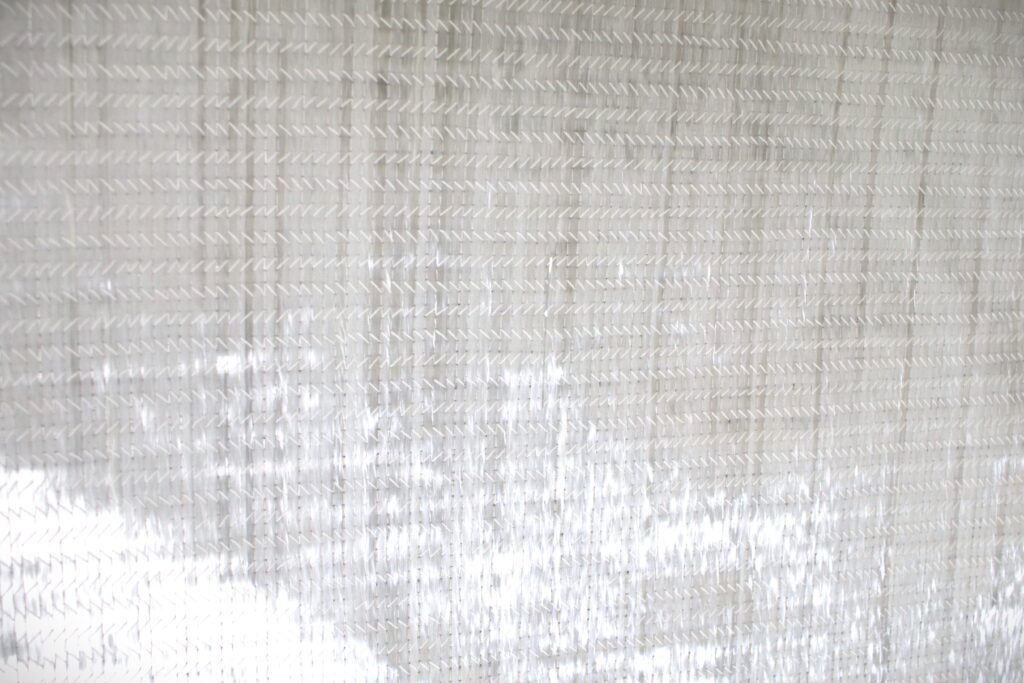 A close up of a sheet of 2408 weight fiberglass cloth