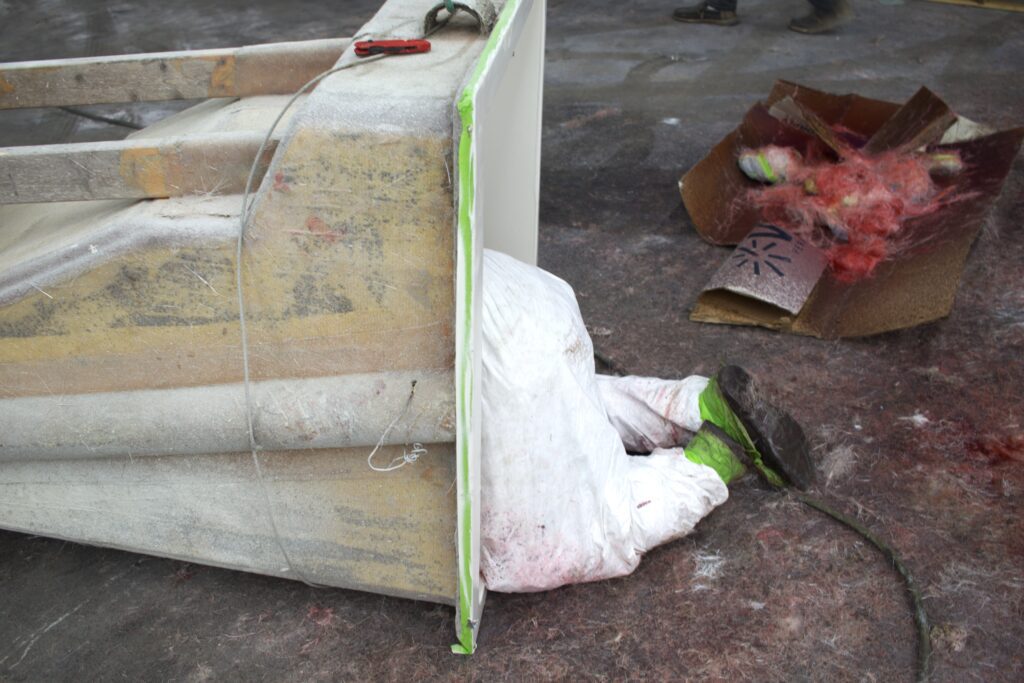 A worker is shown crawling into a console.