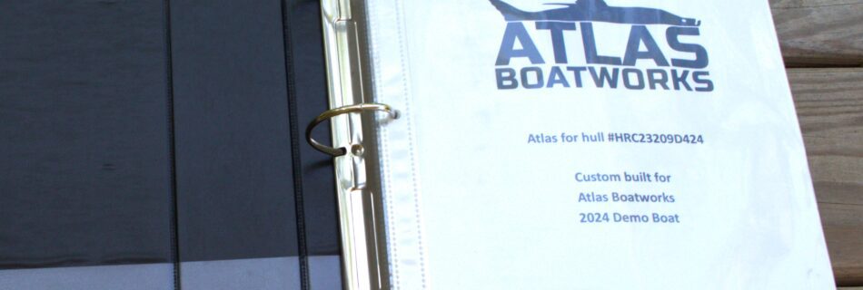 A binder with images of boat systems sits open