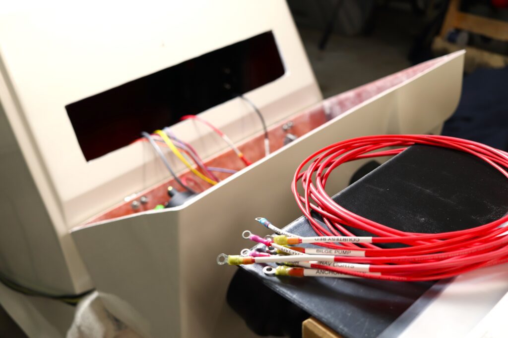 A coil of wires sits in front of a partially rigged center console