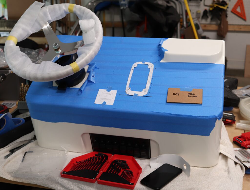 Dashboard of a center console boat is set for rigging with blue tape