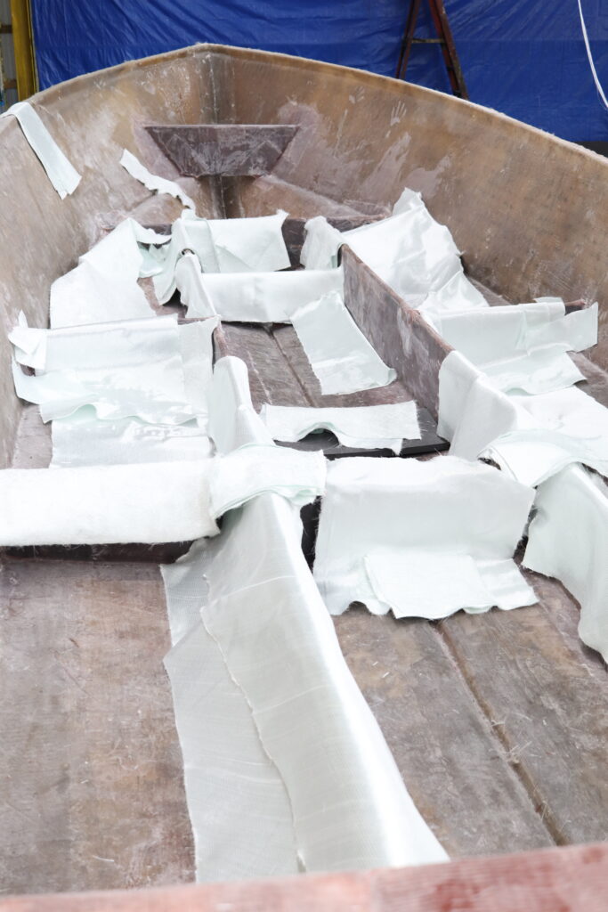 stringers in a boat hull with fiberglass cloth draped over them