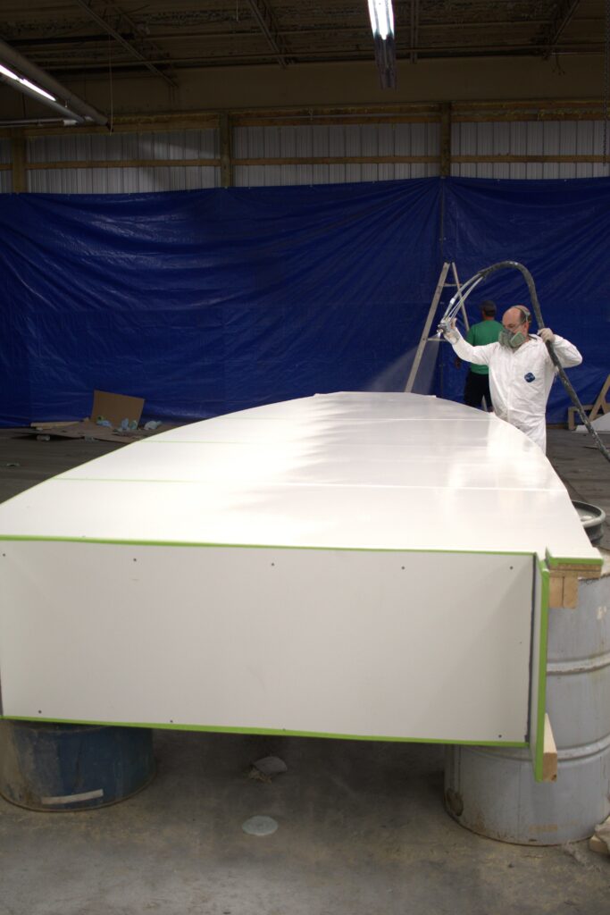 A boat deck mold gets a layer of gelcoat