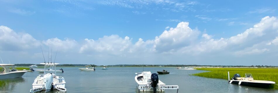 Atlas Boatworks 23F sits anchored in a cove with other boats