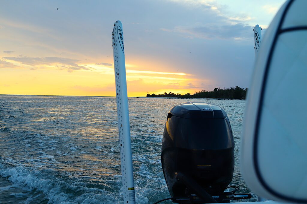 Atlas Boatworks 23F idles away from a colorful sunset