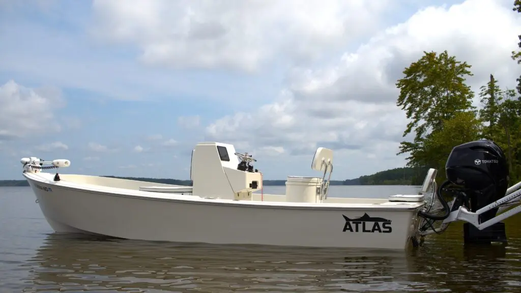 Side profile of a white Atlas Boatworks 23F bay boat at rest