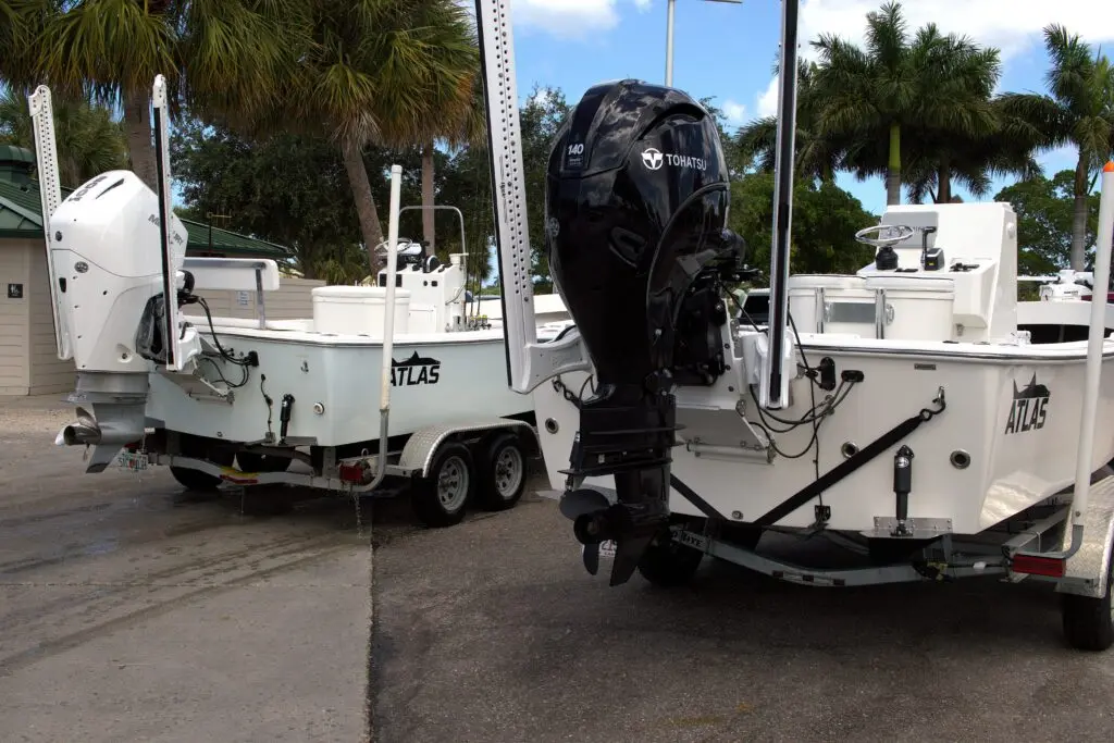 Two Atlas Boatworks 23F bay boats sit next to each other on trailers