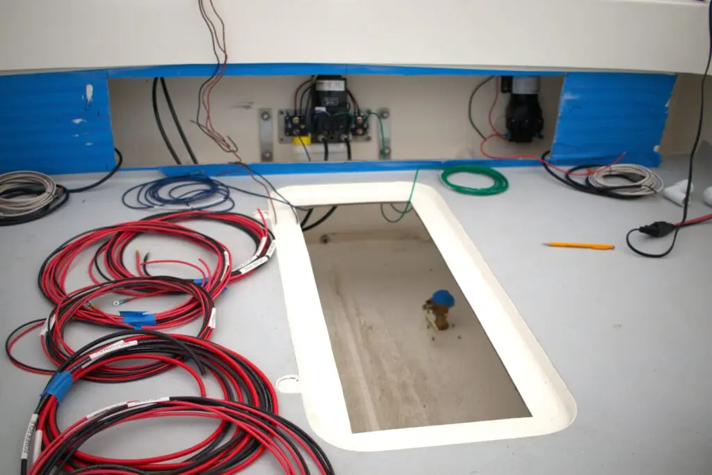 Wires coiled on the deck of an Atlas Boatworks 23F bay boat during the rigging process