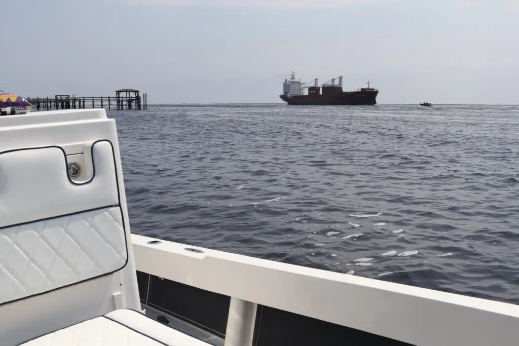 A huge ship passes an Atlas Boatworks 23F bay boat on the Intracoastal Waterway near Southport, NC