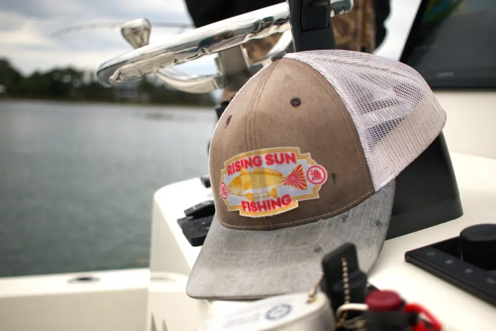 A hat sits on the console of a boat